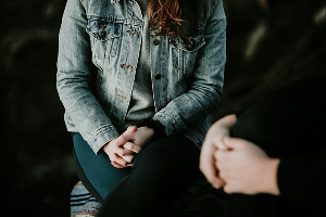 Smiling woman with glasses in a wellness session setting
